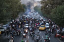 TOPSHOT - A picture obtained by AFP outside Iran on September 21, 2022, shows Iranian demonstrators taking to the streets of the capital Tehran during a protest for Mahsa Amini, days after she died in police custody. Protests spread to 15 cities across Iran overnight over the death of the young woman Mahsa Amini after her arrest by the country's morality police, state media reported today.In the fifth night of street rallies, police used tear gas and made arrests to disperse crowds of up to 1,000 people, the official IRNA news agency said. (Photo by AFP)