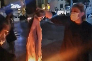 An Iranian protester burns her headscarf in Buchehr on September 25