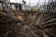 Investigators inspect the crater left by a Russian missile at a Russian power plant in Kharkiv, Ukraine, September 28, 2022.