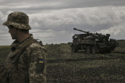 A Ukrainian officer stands in front of a Caesar self-propelled gun on a front line in the Donbas region of eastern Ukraine on June 15, 2022.