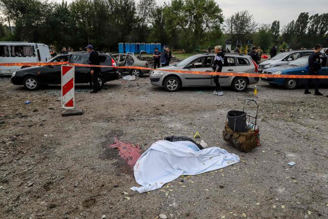 The body of a civilian killed by a missile strike lays on a road near Zaporizhzhia on September 30, 2022.