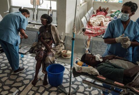 People who were injured in their town Togoga in a deadly airstrike on a market, receive medical treatments at the entrance hall of the Ayder referral hospital in Mekele, on June 24, 2021, two days after a deadly airstrike on a market in Ethiopia's war-torn northern Tigray region, where a seven-month-old conflict surged again. - At least 64 people were killed and 180 were injured in an air strike on a market in Ethiopia's war-torn northern Tigray region, a local health officer said, as the army denied targeting civilians. (Photo by Yasuyoshi CHIBA / AFP)