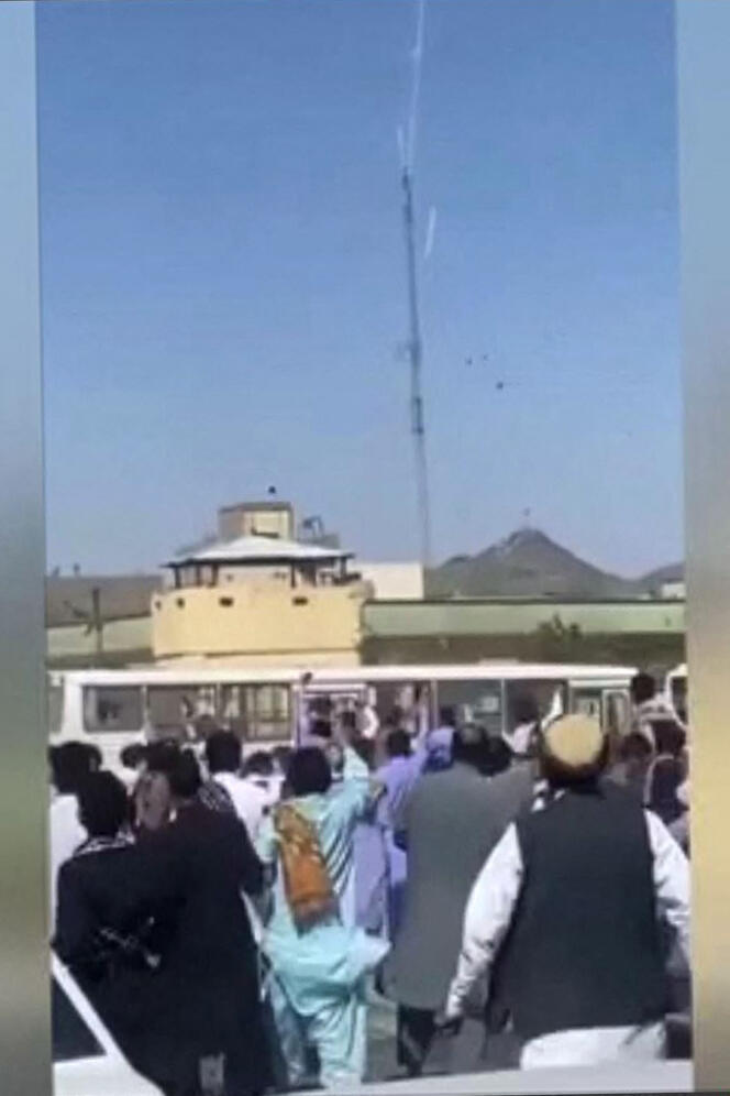 Screenshot taken from a video posted online on September 30, 2022, showing Iranians throwing stones at a police station in the city of Zahedan, in southeastern Iran. 