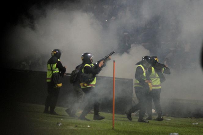 A police officer fires tear gas towards a stand at Kanjuruhan Stadium on Saturday (October 1) in the Malang region of Java Island, Indonesia. 