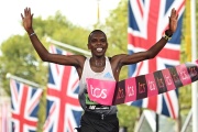 Kenya's Amos Kipruto breaks the tape to win the men's race at the finish of the 2022 London Marathon in central London on October 2, 2022. 