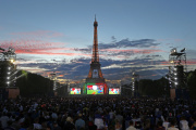 Supporters watch the Euro 2016 final between Portugal and France on giant screens in the Paris fan zone, France, Sunday, July 10, 2016.