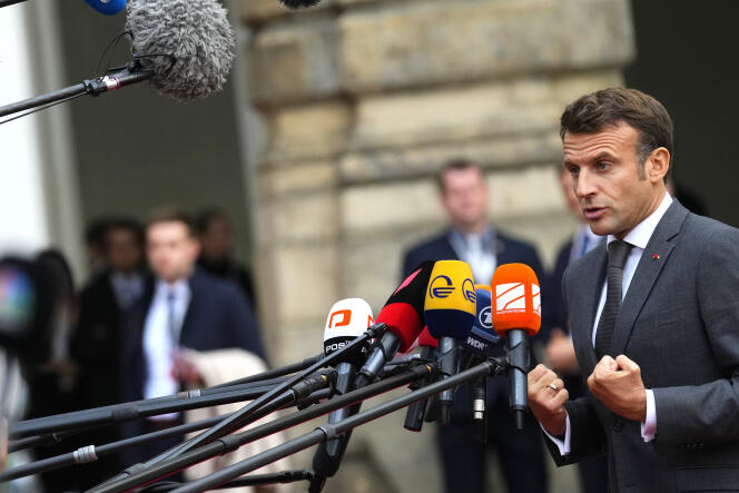 France's President Emmanuel Macron speaks with the media as he arrives for a meeting of the European Political Community at Prague Castle in Prague, Czech Republic, Thursday, October 6, 2022.
