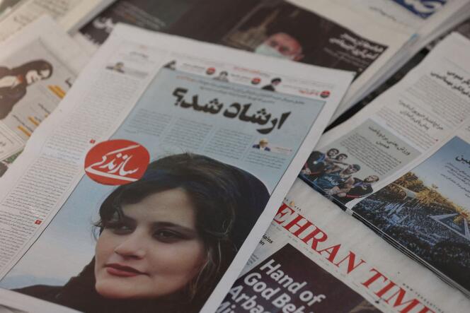 An Iranian newspaper with a cover picture of Mahsa Amini, a woman who died after being arrested by the Islamic republic's 