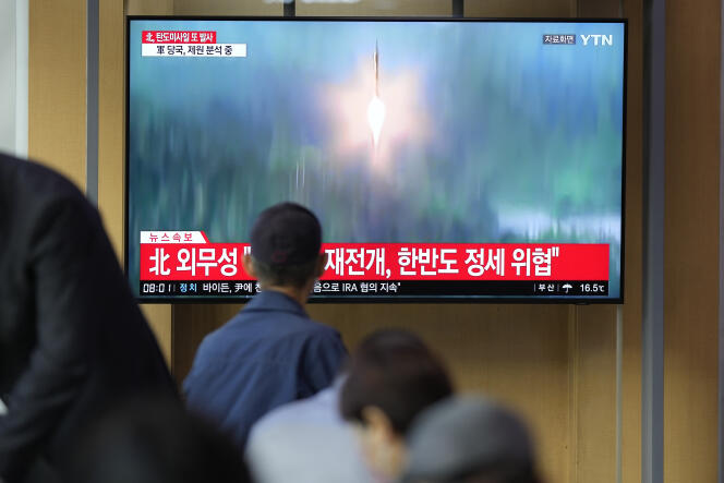 At a train station in Seoul, a television screen broadcasts a news program about North Korea's missile launch on October 6, 2022.