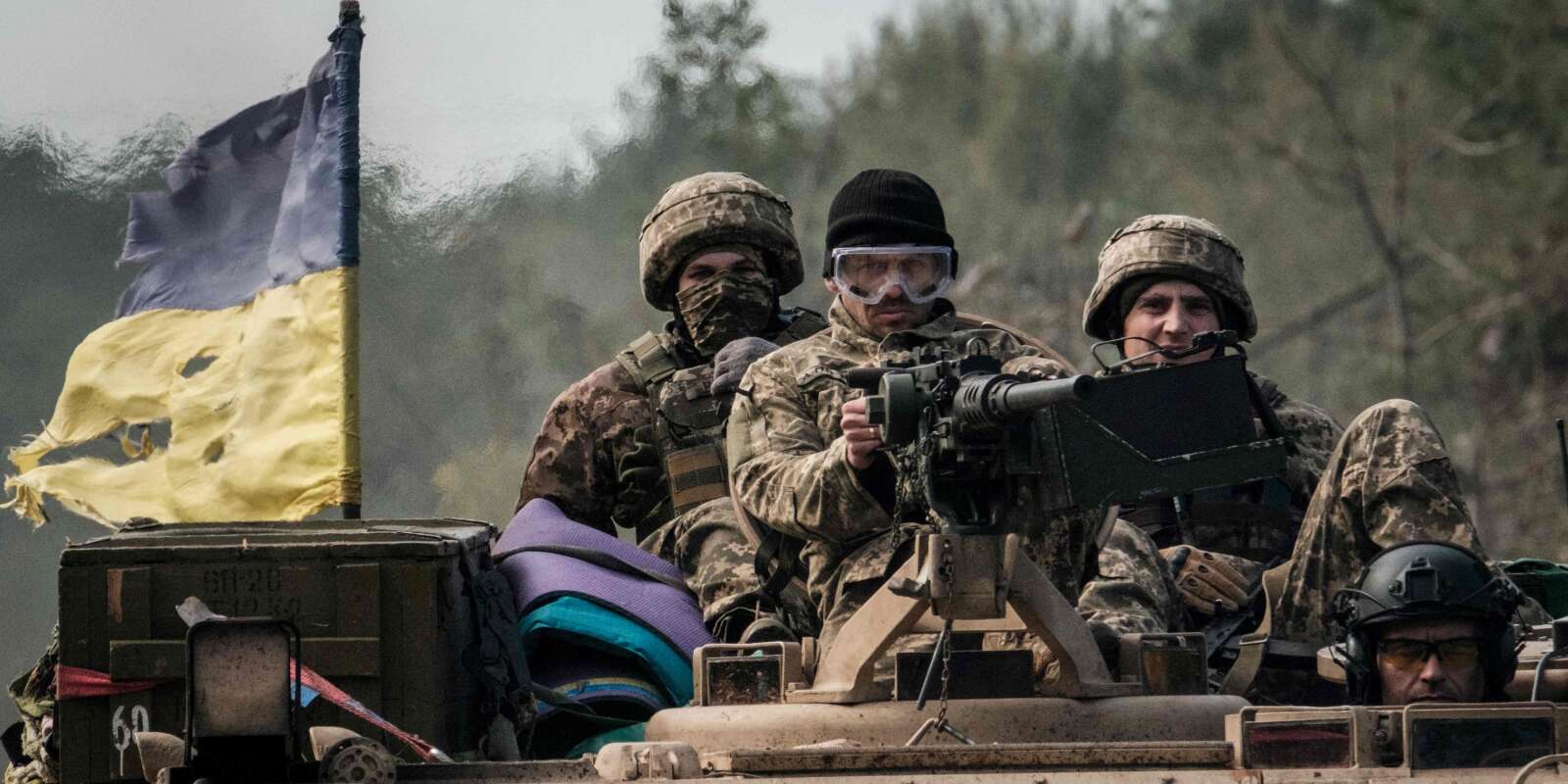 Des soldats ukrainiens montent à bord d’un véhicule blindé près de la ville récemment reprise de Lyman, dans la région de Donetsk, le 6 octobre 2022.