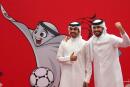 Qataris pose next to an illustration of the Qatar 2022 FIFA World Cup mascot "La'eeb" at the Hayya service centre in the capital Doha on October 16, 2022. Qatar said that more than 1.5 million people have applied for the compulsory pass for the football World Cup, that begins on November 20. (Photo by KARIM JAAFAR / AFP)
