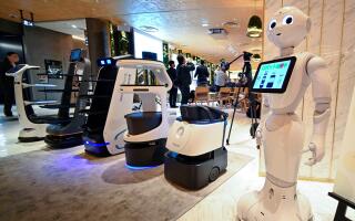 Semi-humanoid robot "Pepper" (R) is pictured with other serving robots at a demonstration by Japan's SoftBank Robotics aimed to help restaurants provide completely unmanned services, in Tokyo on October 18, 2022. (Photo by Kazuhiro NOGI / AFP)