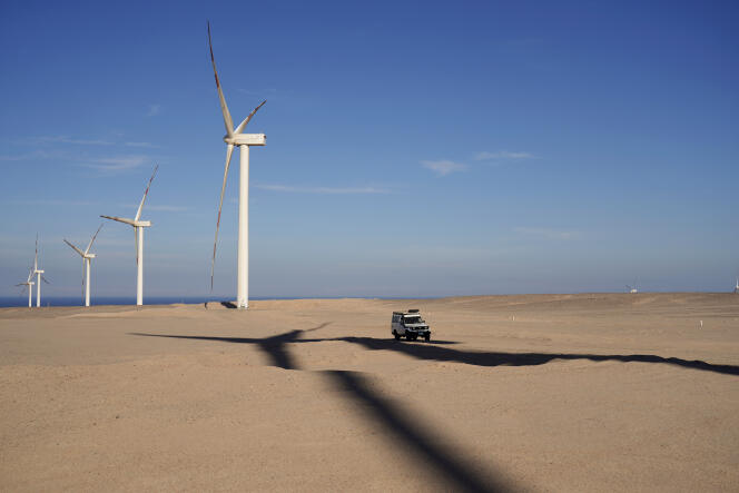 A vehicle drives near wind turbines at Lekela wind power station, near the Red Sea city of Ras Ghareb (some 300 km from Cairo), Egypt. October 12, 2022.