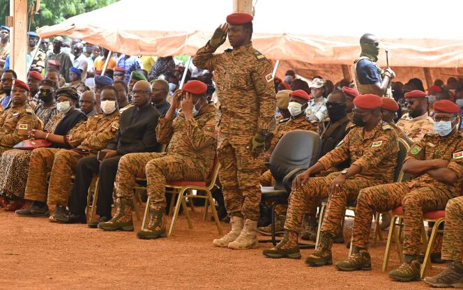Le capitaine Ibrahim Traoré (debout au centre) assiste, à Ouagadougou le 8 octobre 2022, aux funérailles de 27 soldats tués lors de l’attaque d’un convoi. Le Burkina Faso est pris depuis 2015 dans une spirale de violences attribuées à des mouvements djihadistes affiliés à Al-Qaida et au groupe Etat islamique.
