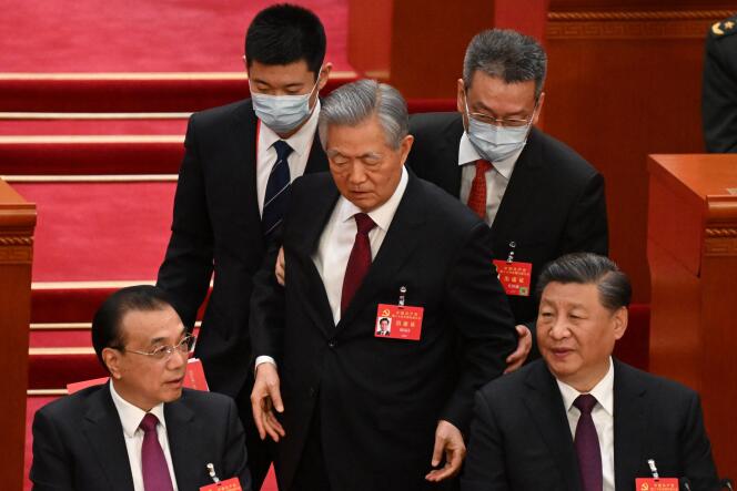 El expresidente Hu Jintao (centro) pasa detrás de Xi Jinping (derecha) y el primer ministro Li Keqiang (izquierda) mientras lo escoltan durante la ceremonia de clausura del XX Congreso del PCCh en el Gran Salón del Pueblo, en Beijing el 22 de octubre.  2022