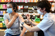 A woman receives a Covid-19 vaccine shot at a pharmacy in Paris on October 19, 2022.
