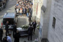 The coffin of 12-year-old schoolgirl, known as Lola, is carried inside the church of Lillers for her funeral ceremony, in Lillers, northern France, Monday, Oct. 24, 2022. France has been "profoundly shaken" by the murder of a 12-year-old schoolgirl, whose body was found in a plastic box, dumped in a courtyard of a building in northeastern Paris. (AP Photo/Michel Spingler)