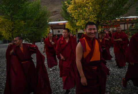 This photograph taken during a government organised media tour in Lhasa, China's central Tibet Autonomous Region, on May 31, 2021 shows monks having a walk at the Tibet Autonomous Region Buddhist College. (Photo by Hector RETAMAL / AFP)