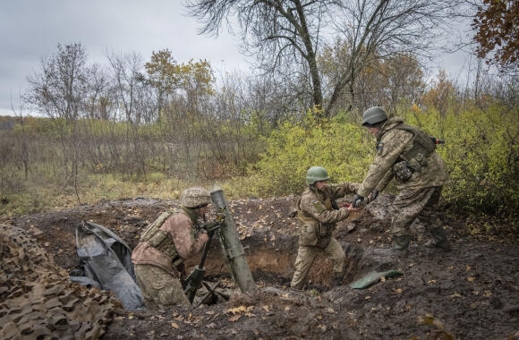 Ukrainian soldiers fire a mortar at the front line near Bakhmut, in the Donetsk region, on October 27, 2022.