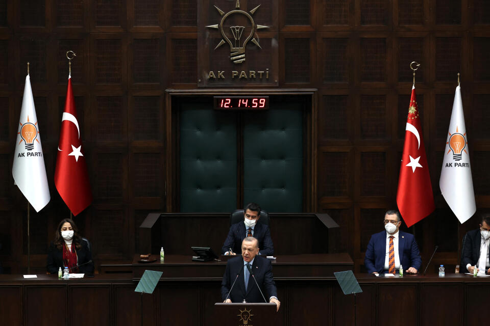 Turkish President and leader of the Justice and Development Party (AK Party) Recep Tayyip Erdogan (C) delivers a speech during his party’s group meeting at the Turkish Grand National Assembly in Ankara on January 12, 2022. (Photo by Adem ALTAN / AFP)