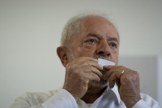 Former Brazilian President Luiz Inacio Lula da Silva, who is running for president again, kisses his ticket after voting in a run-off presidential election in Sao Pablo, Brazil, Sunday, October 30, 2022. 