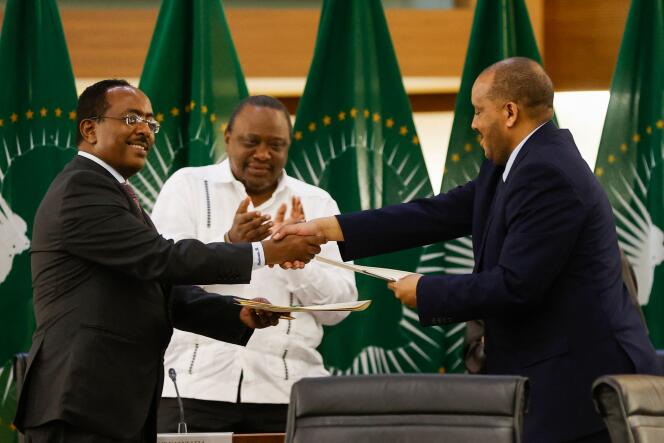 Ethiopian government representative Redwan Hussein Rameto (left) and Tigray rebel representative Kedachu Reda (right) shake hands during peace talks in Pretoria, Wednesday, Nov. 2, 2022. 