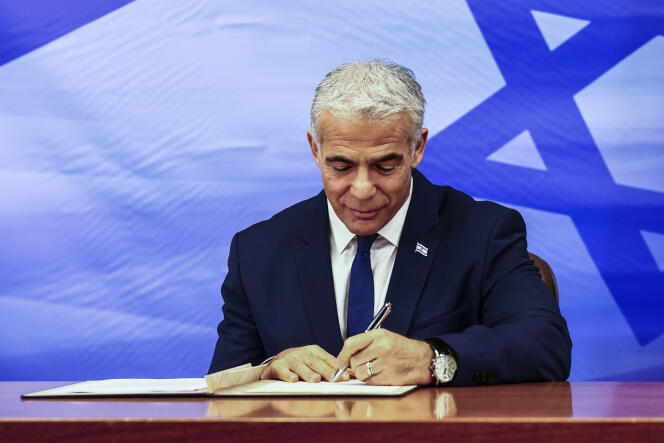 Israeli Prime Minister Yair Lapid signs a U.S.-brokered deal setting a maritime border between Israel and Lebanon, at the Prime Minister's office in Jerusalem, Thursday, October 27, 2022.