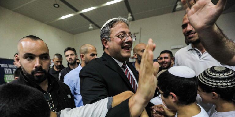 Itamar Ben-Gvir, Israeli far-right lawmaker and leader of the Otzma Yehudit (Jewish power) party, greets supporters during a rally in the southern Israeli city of Sderot on October 26, 2022. (Photo by GIL COHEN-MAGEN / AFP)
