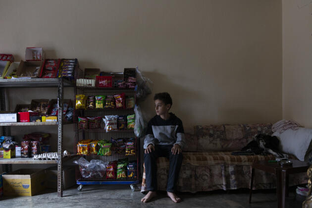 Omar Abbas, the nephew of Siham Abbas, who sells groceries in her apartment in Haryk, northern Lebanon, on November 1, 2022.