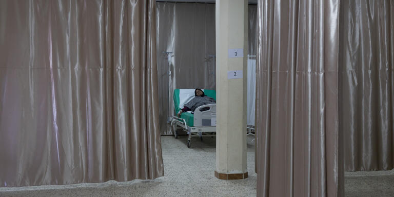 A patient, lying on a bed, receives treatment at the basement of a medical center where patients with symptoms of cholera are treated in Bebnine, Akkar, north of Lebanon, Tuesday, November 1, 2022.