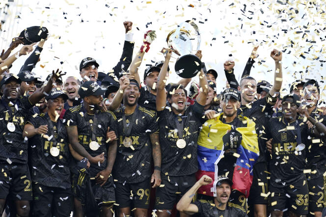 Los Angeles FC's Carlos Vela hoists the trophy alongside teammates after defeating the Philadelphia Union in a penalty kick shootout to win the MLS Cup soccer match Saturday, November 5, 2022, in Los Angeles.