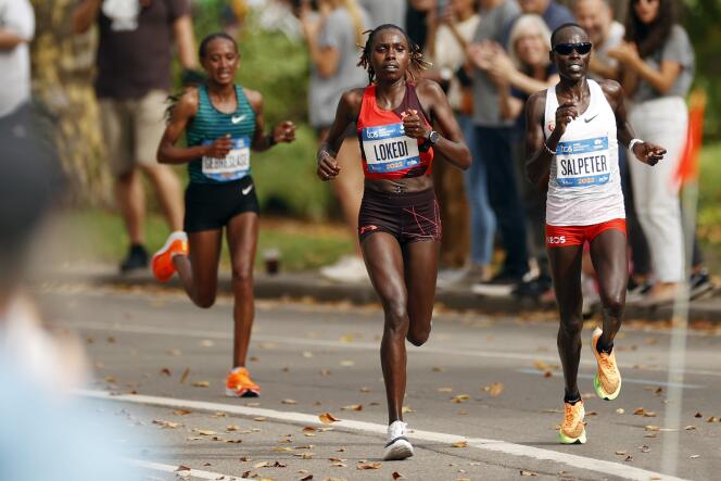 Sharon Lokedi of Kenya (wearing red) competes in the women's race of the  New York City Marathon on November 6, 2022 in New York City.  
