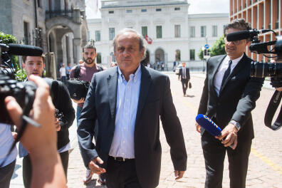 FILE - The former president of the the European Football Association (UEFA) Michel Platini, center, is leaving the Swiss Federal Criminal Court in Bellinzona, Switzerland, after the first day of his trial, Wednesday, June 8, 2022. Picking Qatar to host the World Cup was a mistake 12 years ago, FIFA’s president at the time Sepp Blatter said Tuesday, Nov. 8, 2022, again citing a meeting between Nicolas Sarkozy and Michel Platini for swaying key votes. (Ti-Press/Alessandro Crinari/Keystone via AP, File)