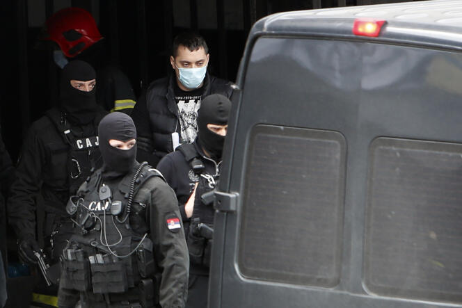 Serbian police officers escort Veljko Belivuk, leader of the ultra supporters of Partizan, the Belgrade football club that has become a beacon of the underworld, during a raid on the Partizan stadium in Belgrade February 4, 2021.