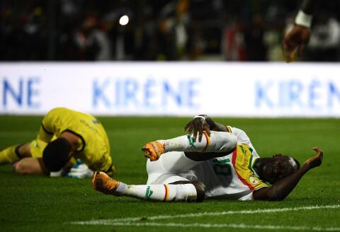 (FILES) In this file photo taken on September 24, 2022 Senegal's forward Sadio Mane (R) reacts on the ground during the friendly football match between Bolivia and Senegal in Orleans, central France. Senegal star Sadio Mane has been ruled out of the 2022 World Cup because of an injury to his right fibula, the country's football Federation announced on November 17, 2022. (Photo by Christophe ARCHAMBAULT / AFP)
