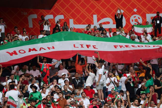 A banner in support of Iranian women is held aloft during the match between Iran and England