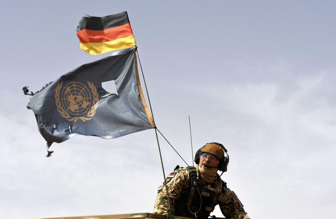 In this file photo taken on August 03, 2018, a German soldier from the parachutists detachment of the MINUSMA (United Nations Multidimensional Integrated Stabilization Mission in Mali) search for IED (improvised explosive device) during a patrol on the route from Gao to Gossi, Mali. 