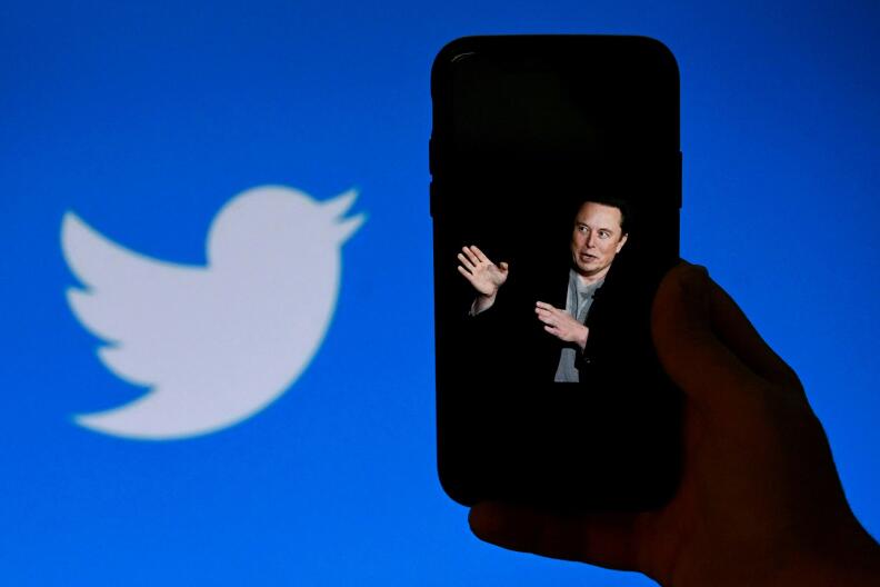 (FILES) In this file photo taken on October 4, 2022, a phone screen displays a photo of Elon Musk with the Twitter logo shown in the background, in Washington, DC. A landslide of Twitter users responding to an informal poll by new owner Elon Musk voted in favor of a general amnesty for suspended accounts on the platform. The "yes/no" informal poll comes as Musk faces pushback that his criteria for content moderation is subject to his personal whim, with reinstatements decided for certain accounts and not others. Of 3.16 million respondents to Musk's tweeted poll question, 72.4 percent said Twitter should allow suspended accounts back on Twitter as long as they have not broken laws or engaged in "egregious spam," Musk posted. - (Photo by OLIVIER DOULIERY / AFP)