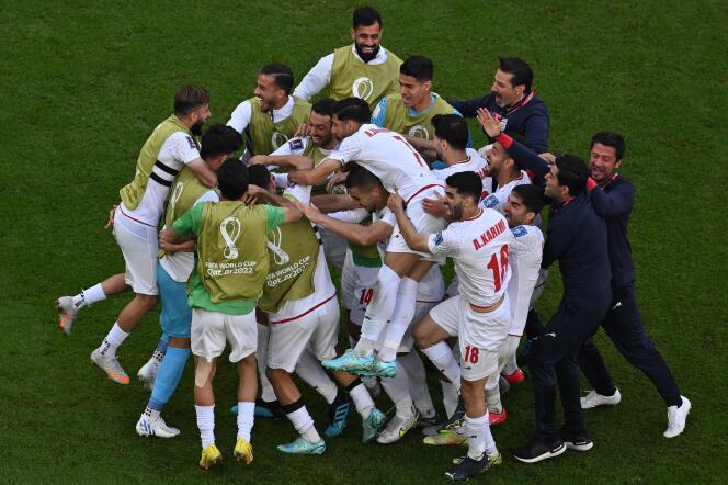 Iranian footballers celebrate the opening match against Wales on November 25. 