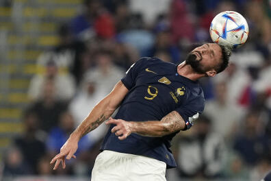 France's Olivier Giroud heads the ball during the World Cup group D soccer match between France and Denmark, at the Stadium 974 in Doha, Qatar, Saturday, Nov. 26, 2022. (AP Photo/Martin Meisner)