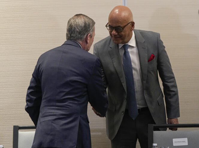 President of Venezuela's National Assembly Jorge Rodriguez (right) shakes hands with Venezuelan opposition representative Gerardo Plait Perez after signing an agreement to create a UN-run fund to finance health, food and education programs for the poor in Mexico City, November 26, 2022.