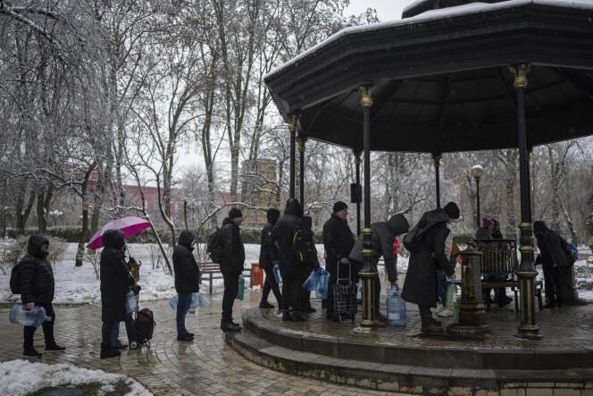 People wait in line to collect water, in Kyiv, Ukraine, November 24, 2022. 