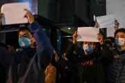 Protestors brandishing blank sheets of paper in protest, in Shanghai on November 27, 2022.