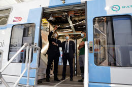 French President Emmanuel Macron inspects a RER A train, which is to be refurbished, during a visit to the railway manufacturer CAF factory in Bagnères-de-Bigorre factory, southwestern France, on July 16, 2021. - Macron is on a two-day visit in southwestern France, notably to attend stages of the 108th edition of the Tour de France cycling race. (Photo by Ludovic MARIN / AFP)