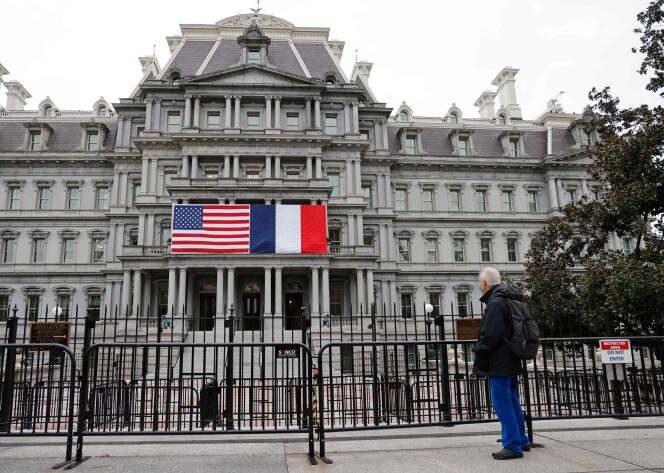 French and American flags adorn the Eisenhower Executive Office Building, next to the White House, for French President Emmanuel Macron's state visit to Washington, November 29, 2022.