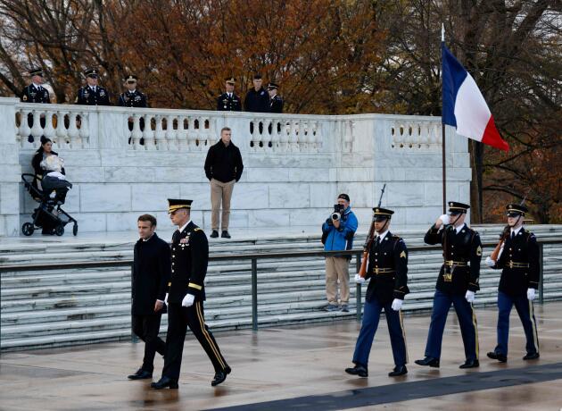 French President Emmanuel Macron (L) tours the Tomb of the Unknown Soldier while visiting Arlington National Cemetery in Arlington.