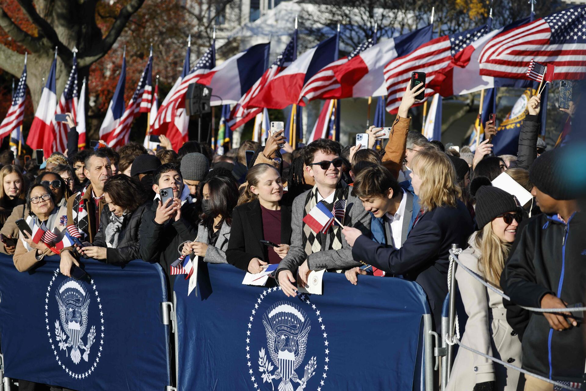 Visitors await the arrival of French President Emmanuel Macron and his wife Brigitte Macron to the White House in Washington, DC, on December 1.