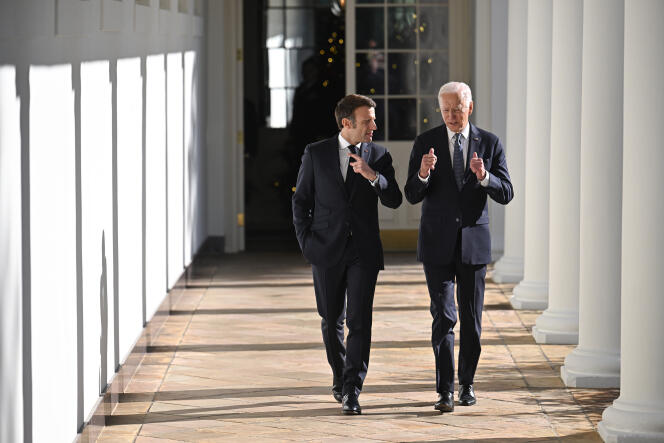 President Joe Biden and French President Emmanuel Macron walk along the Colonnade of the White House in Washington, December 1, 2022. 