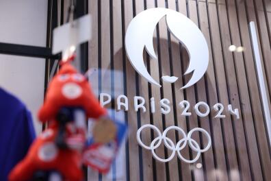 This photograph taken on November 15, 2022, in Paris, shows the Paris 2024 Olympic and Paralympic Games official logo, displayed in the official Paris 2024 shop in Les Halles shopping mall in central Paris. - The Olympic and Paralympic mascots are named "Les Phryges" and represent French revolutionary Phrygian caps. (Photo by Thomas SAMSON / AFP)
