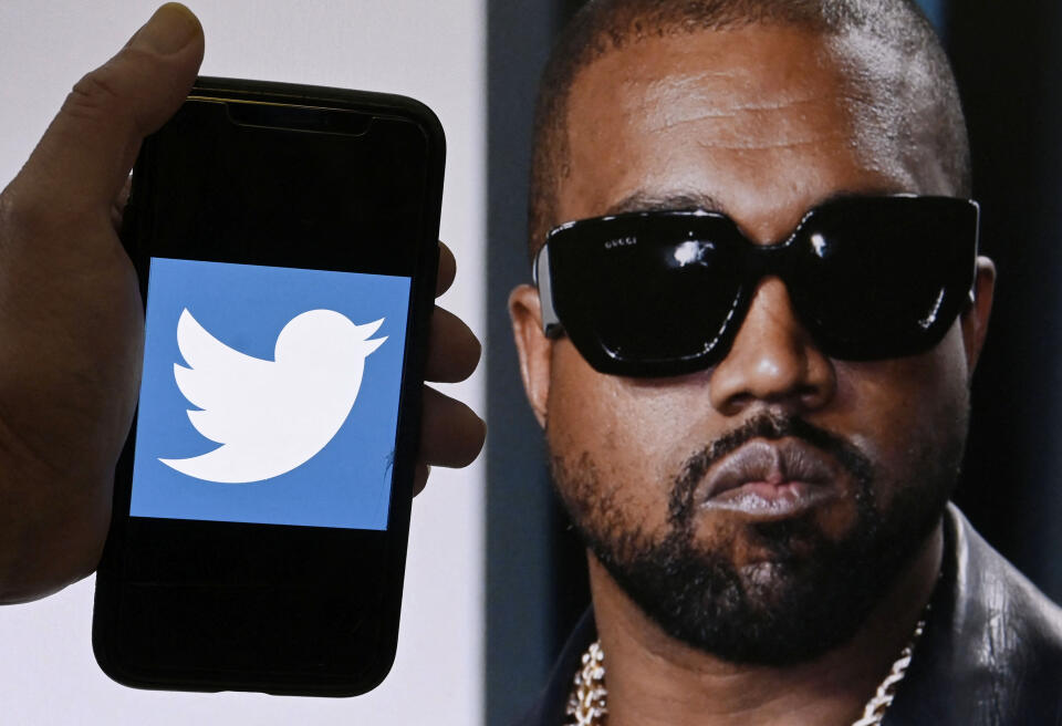 (FILES) In this file photo illustration, the Twitter logo is displayed on a mobile phone with a photo of Kanye West shown in the background on October 28, 2022 in Washington, DC. Kanye West was knocked off social media platform Twitter on Friday, Elon Musk said, after posting a picture that appeared to show a swastika interlaced with a Star of David.
"Just clarifying that his account is being suspended for incitement to violence," Musk said in response to West's tweet. (Photo by OLIVIER DOULIERY / AFP)
